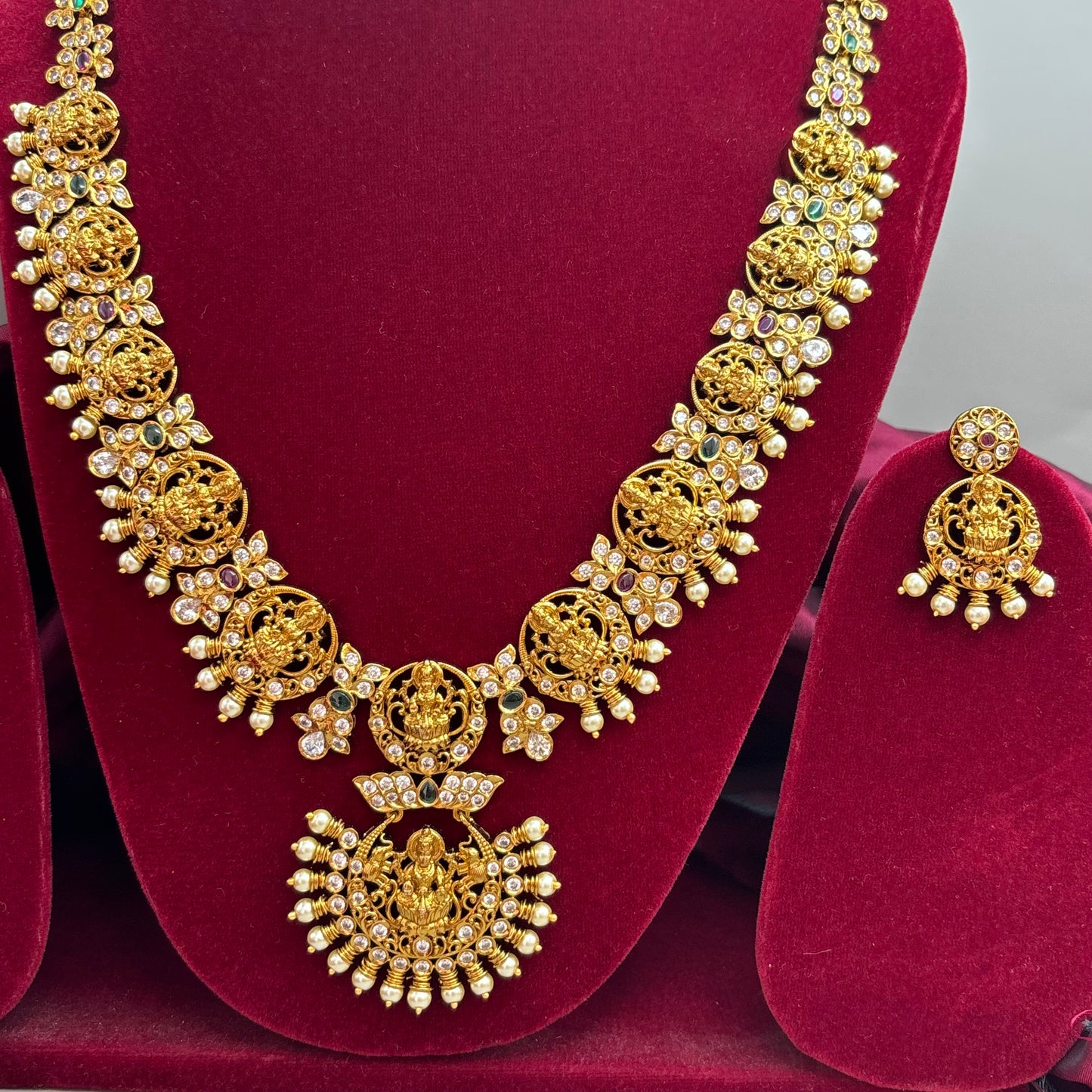 Beautiful temple design long haram sets with cubic zirconia stones
