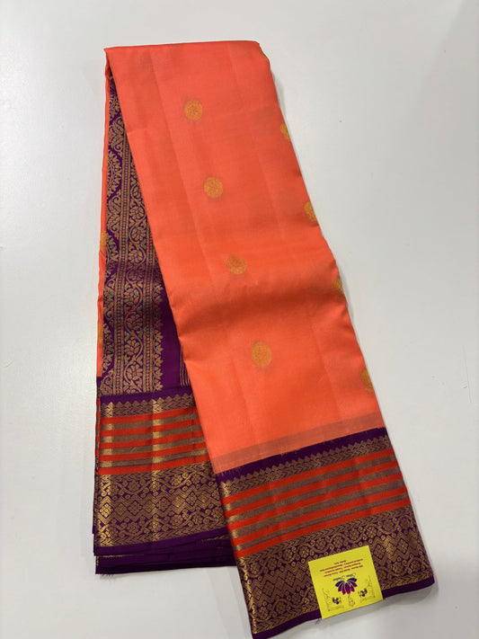 Elegant Peach‑Orange Silk Saree Featuring Classic Purple Highlights & Traditional Zari Accents