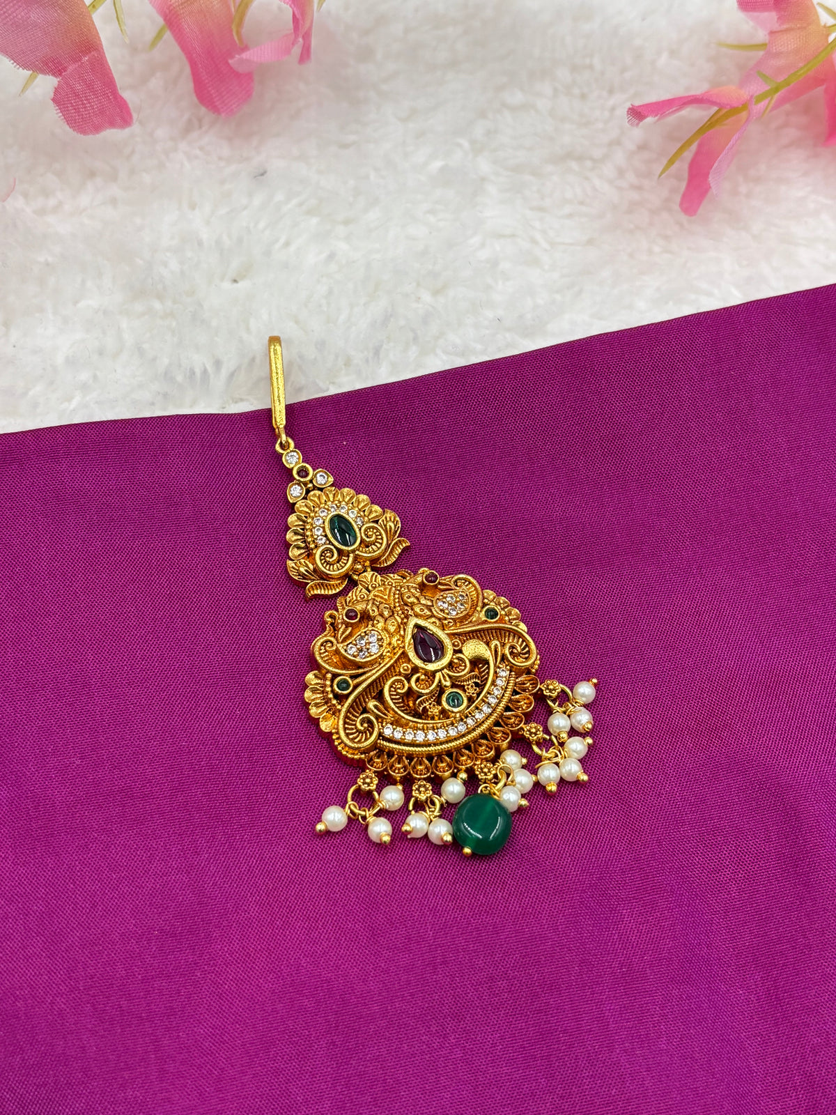 Elegant Gold Finish Tikka – Peacock Pattern with Pink Stones