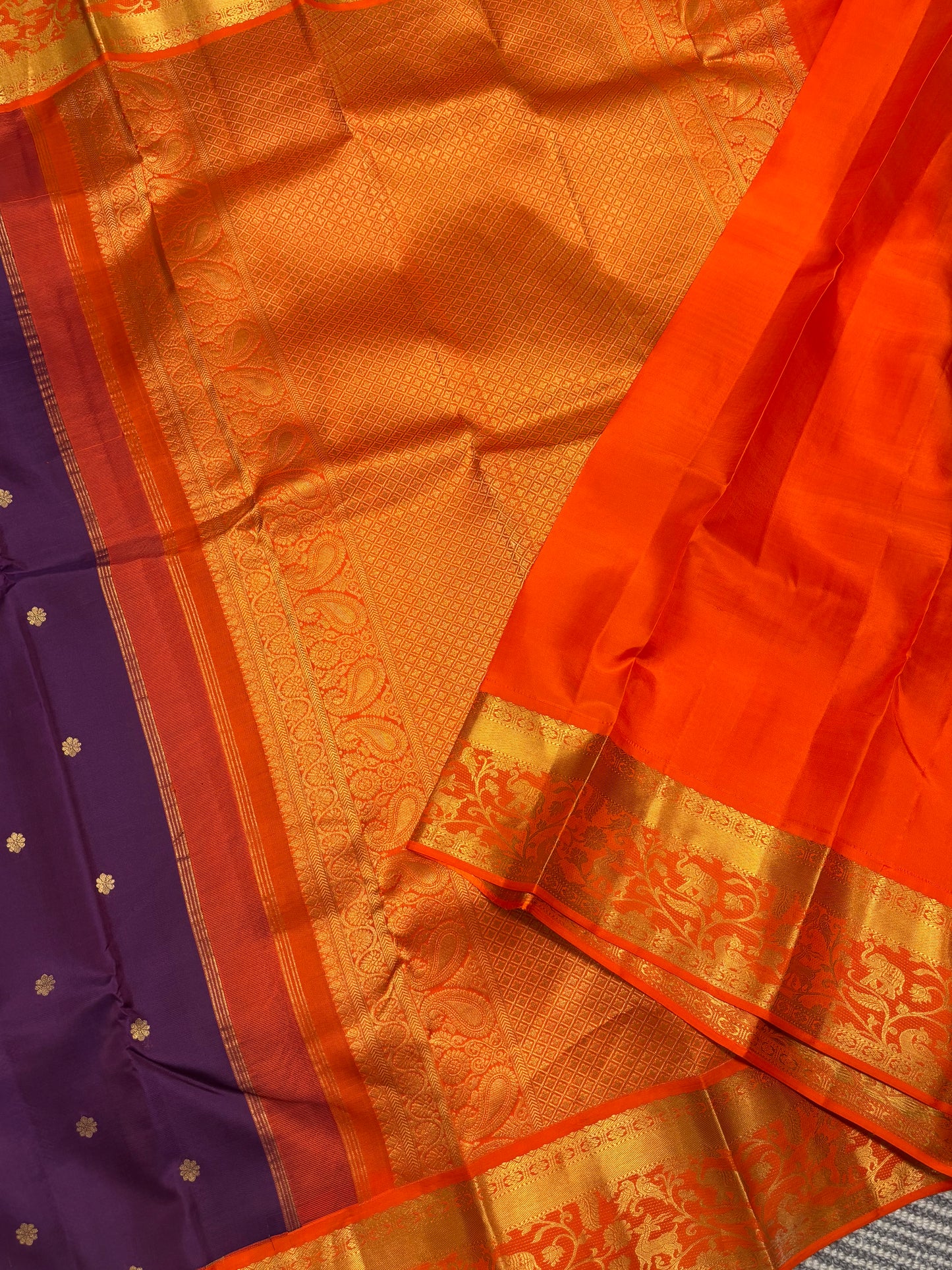 Elegant Purple Kanchipuram Silk Saree Featuring Orange Contrast and Floral Buttas